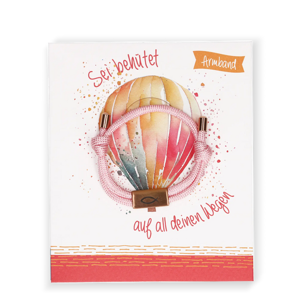Rosa Textil-Armband „Sei behütet auf all deinen Wegen“ mit christlichem Fischsymbol – Geschenkarmband mit Ballonmotiv auf Karte.