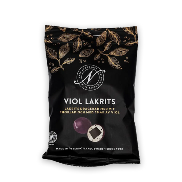 schwarze Tüte, Foto von Lakritzdragee aufgeschnitten und von aussen, goldene Blätter